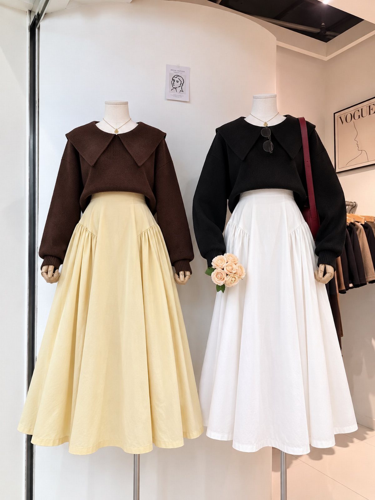 Two mannequins wearing cropped collared sweaters and high-waisted A-line midi skirts in neutral colors.
