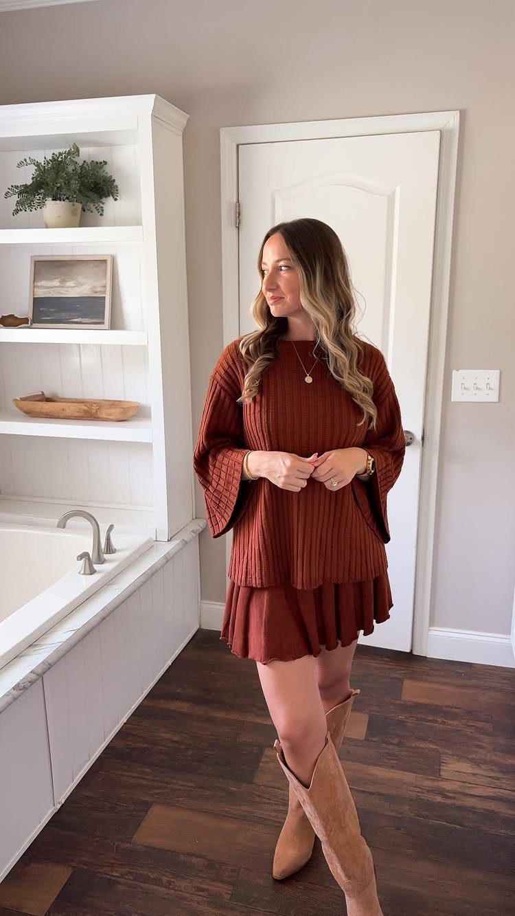 Woman wearing a rust-colored ribbed knit sweater and matching skirt with tan suede boots.