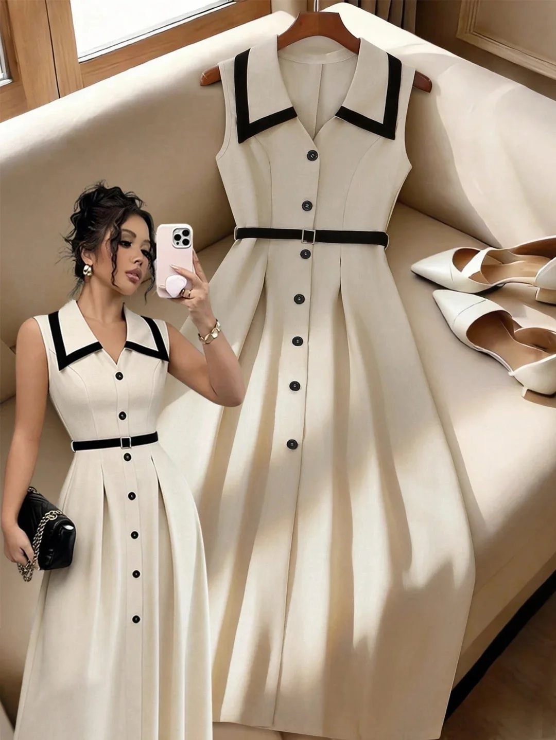 Woman in a cream sleeveless midi dress with black trim posing for a mirror selfie.